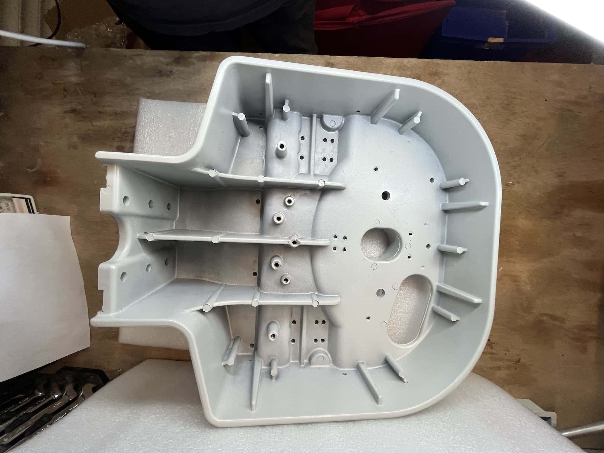 Internal view of a large aluminium pressure die-cast housing showing cast ribs, bosses and cored holes